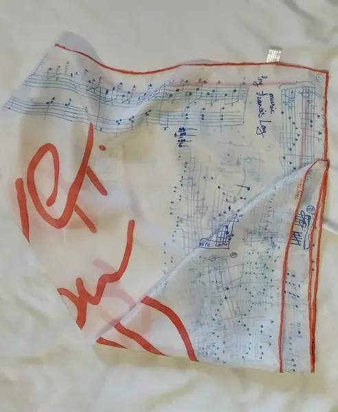 Image of Scarf "Love story. Music by Frаncis Lay" by Tetiana Kononenko (Tanta), size: 89х89 см, made of silk 100%, acrylic for silk, resist, textile marker, batik medium, part of the "Batik" series Photo 3 of 5.